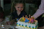 Blowing out the candle on her Princess cake...