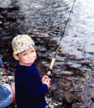 Eion Kane, fishing...and saving some candy in his cheek.